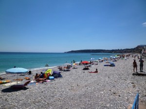 The Menton waterfront and pebbly beach looking west towards Cap Martin